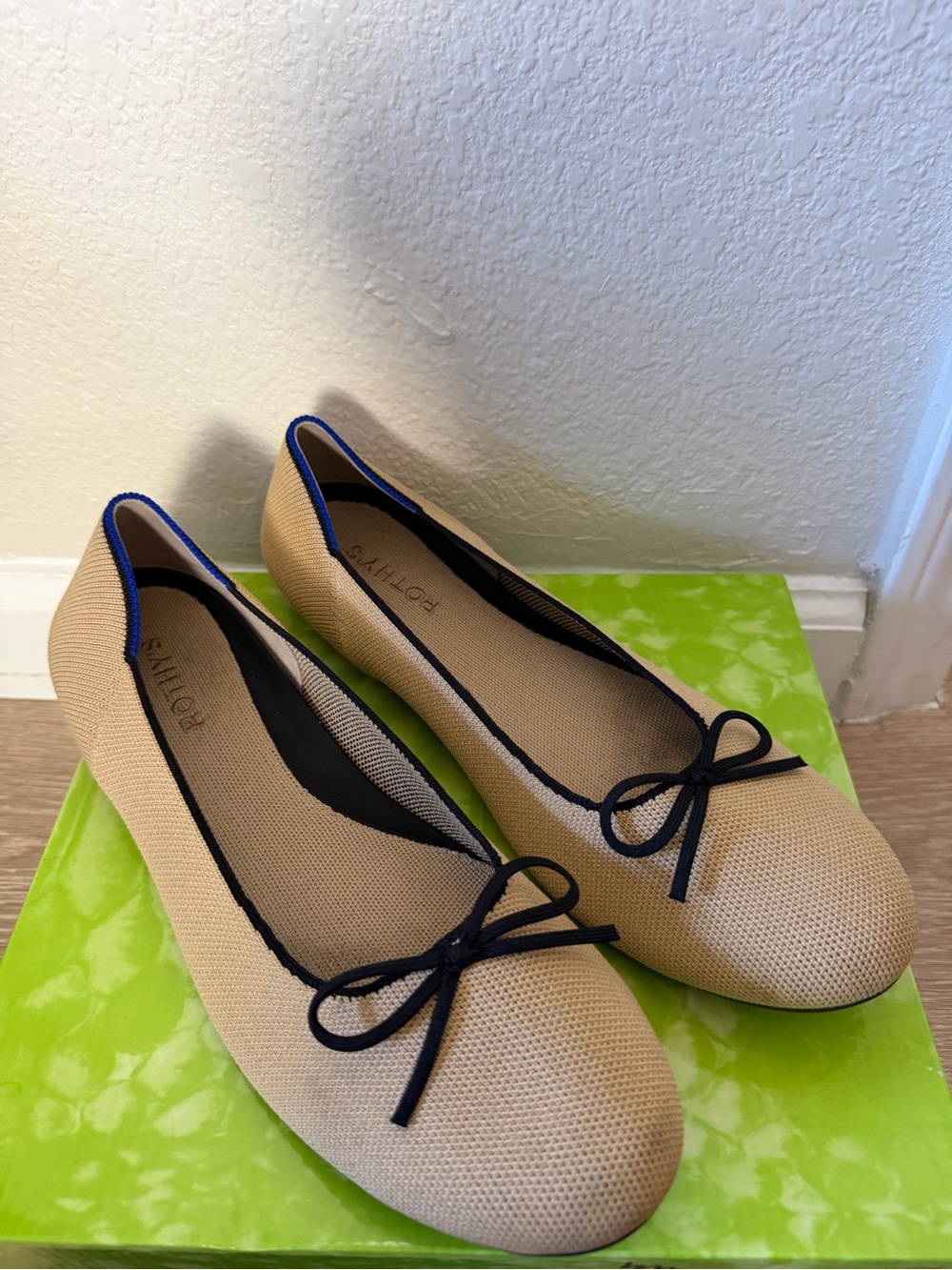 Rothy's Beige Ballet Flats with Black Trim and Bow Detail